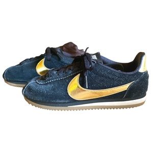 Nike black suede with gold swoosh sneakers